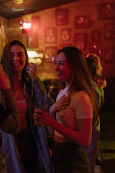 A lively group of young women enjoying a night out in a vibrant bar setting.