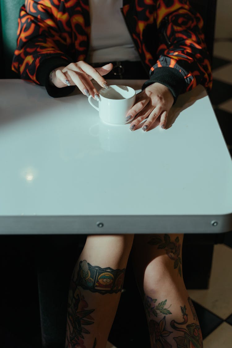 Person Holding A White Ceramic Cup