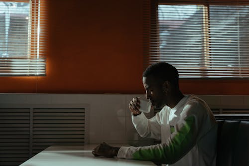 Man Wearing Long Sleeve Shirt Drinking Coffee