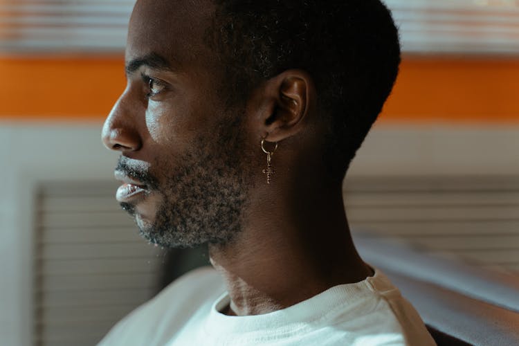 Man In White Crew Neck Shirt With An Earring