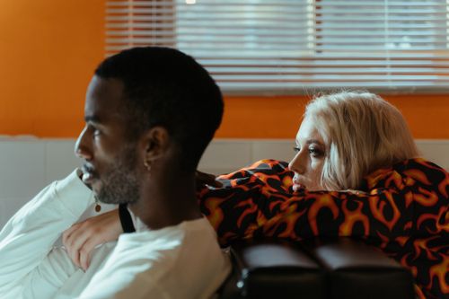 Free An interracial couple enjoying a close moment indoors, symbolizing love and comfort. Stock Photo