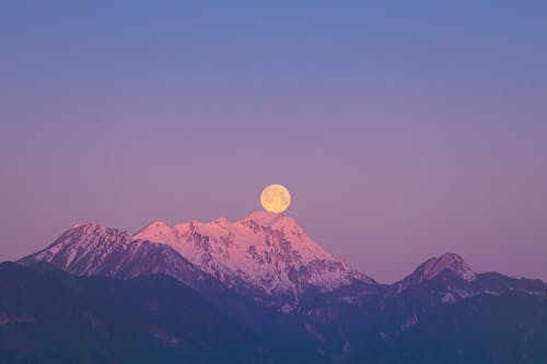 Full Moon Over Snow Covered Mountain