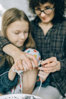 Mother Teaching Her Daughter Knitting