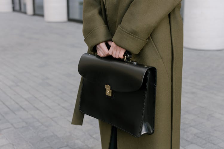 Person Holding A Black Briefcase