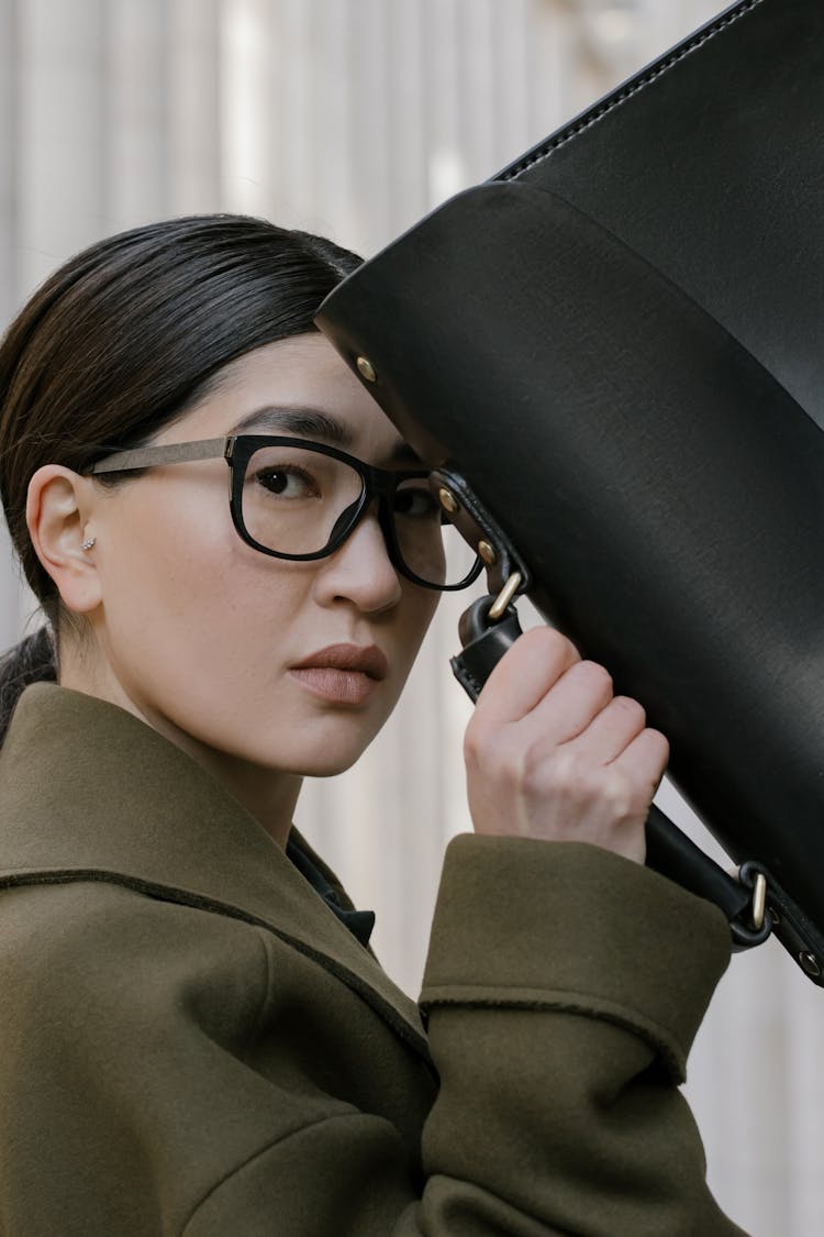 Woman In Eyeglasses Holding A Briefcase