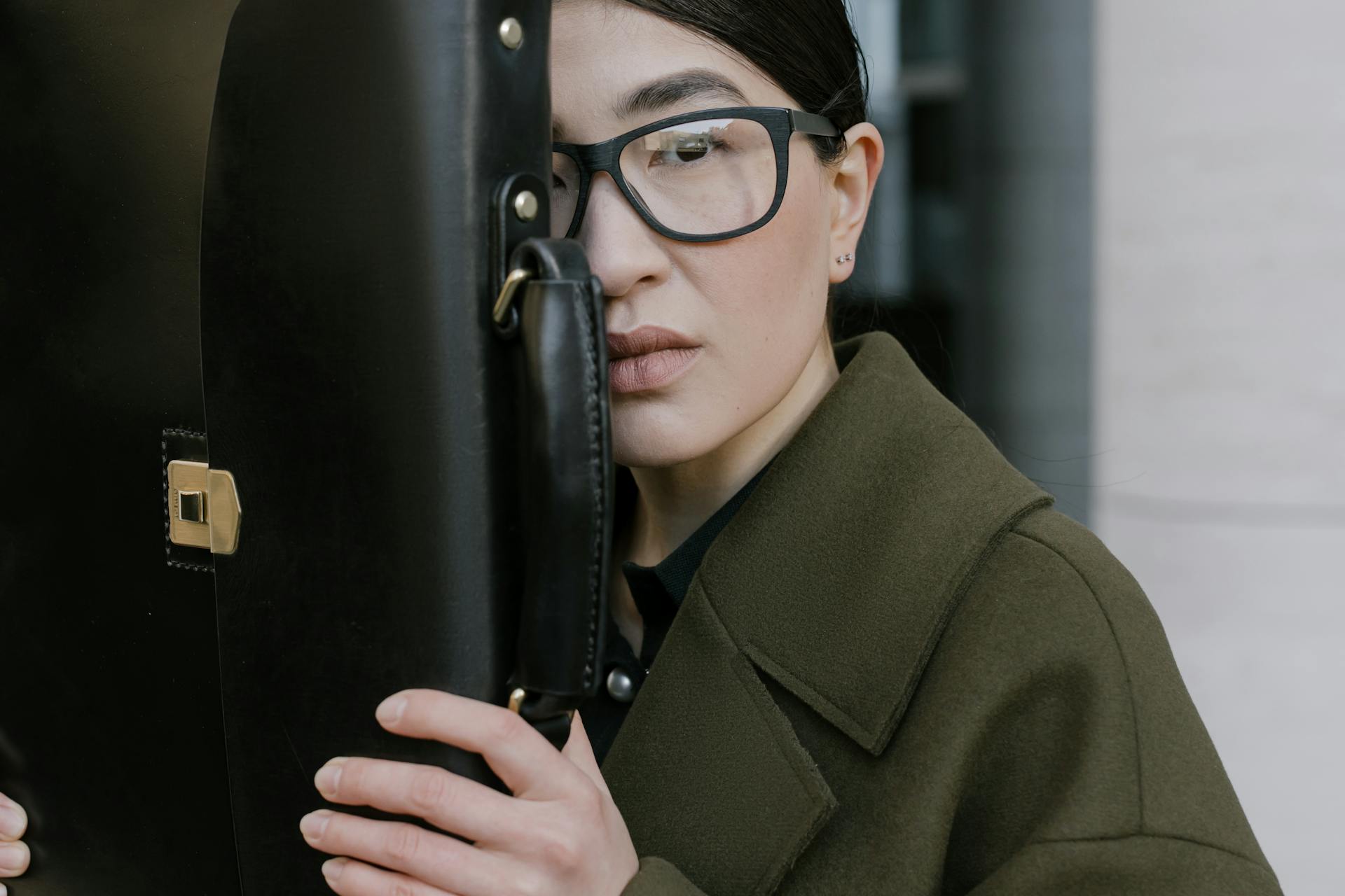 Woman in Black Framed Eyeglasses Holding a Briefcase