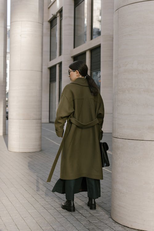 Free A Woman Standing Beside the Column Stock Photo