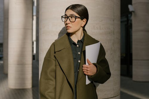 Free Woman in Brown Coat Holding White Paper Stock Photo