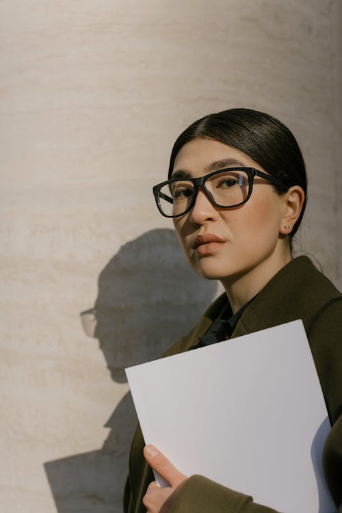 Free Girl in Green Coat Wearing Black Framed Eyeglasses Stock Photo