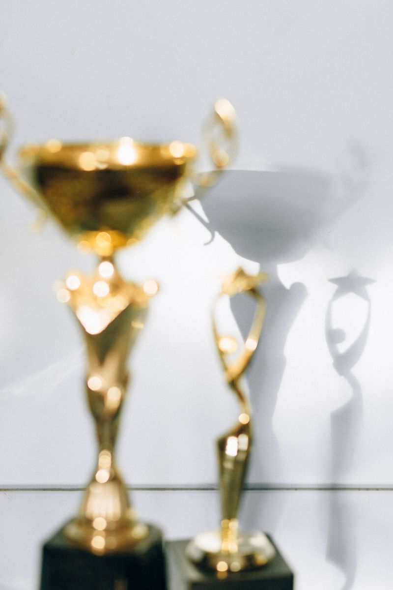 Crystal and gold award trophies with soft lighting