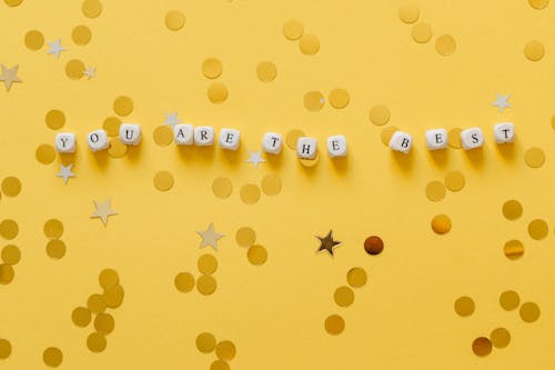 Free Close-Up Shot of Dices on a Yellow Surface Stock Photo