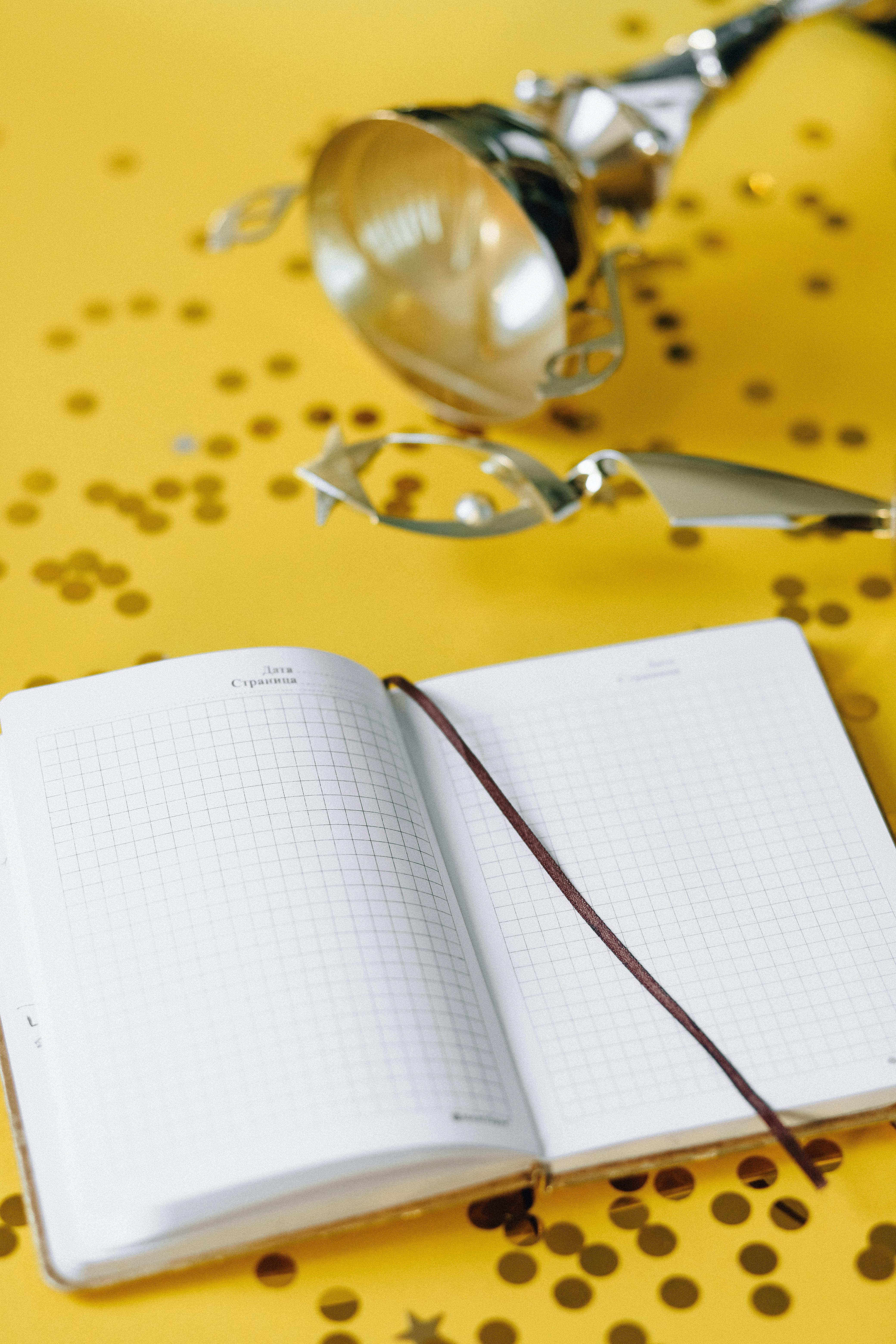 white book page on yellow and white floral textile