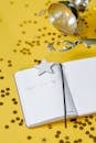 White Notebook Beside Silver Framed Eyeglasses