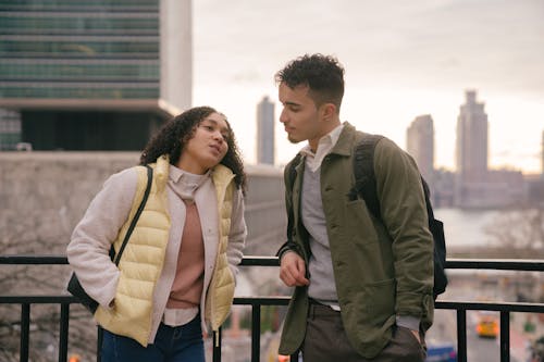 Hispanic couple talking on urban street