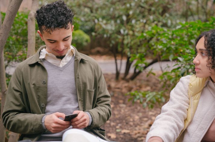 LGBTQ+ couple holding hands on a walk in the park