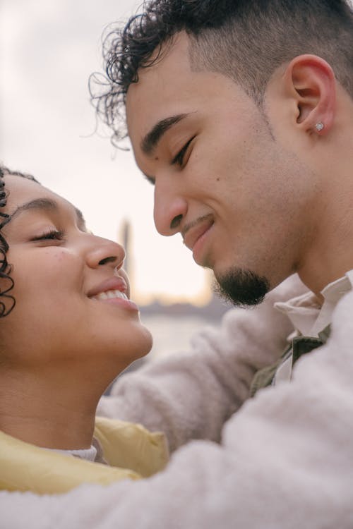 Hispanic happy couple smiling and cuddling