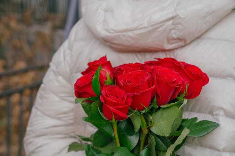 Anonymous Person Hiding Bunch Of Fresh Roses Behind Back