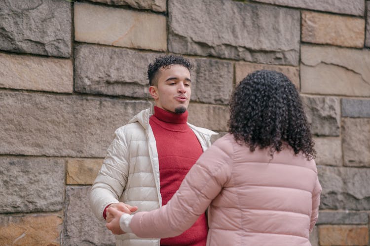 Ethnic Couple Holding Hands While Dancing Together