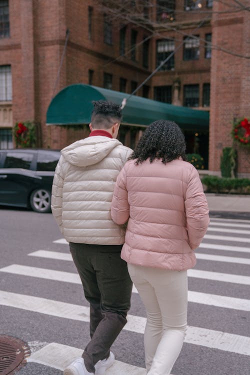 Couple crossing city street in daytime