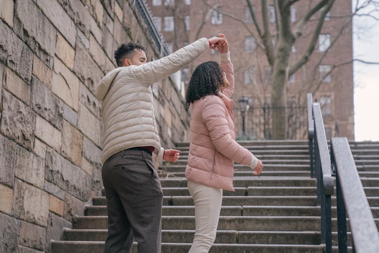 Ethnic Couple Dancing On Street In Daytime