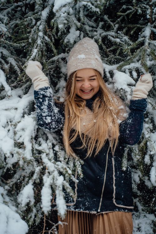 Free Cheerful young woman playing in snow outdoors in Munich, capturing the joy of winter. Stock Photo