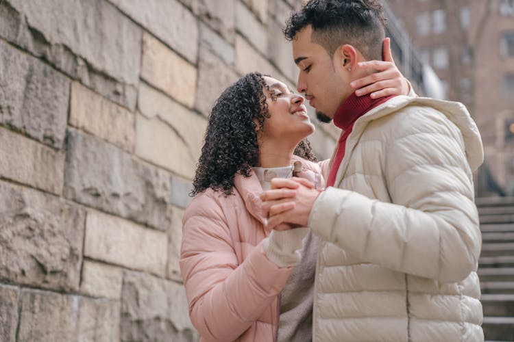 Loving Hispanic Couple Caressing On Street