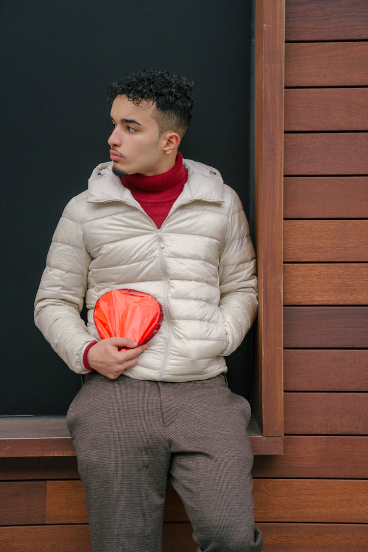 Serious Hispanic Man With Gift Box