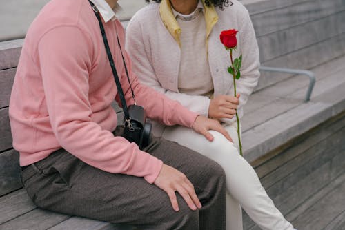 Free Crop loving couple with flower on street Stock Photo