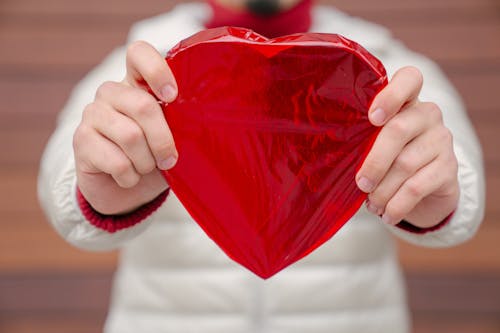 Free Crop man showing wrapped present Stock Photo