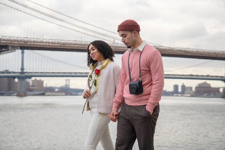 Content Hispanic Couple Walking On Waterfront