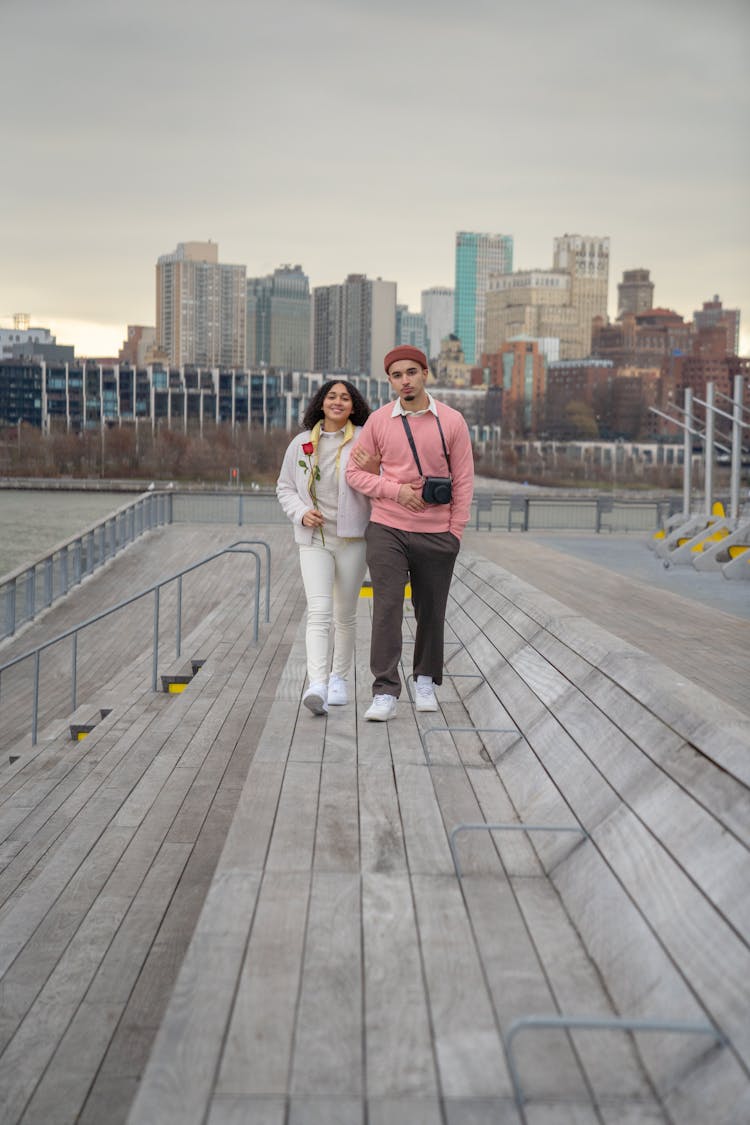 Romantic Hispanic Couple Walking On Embankment