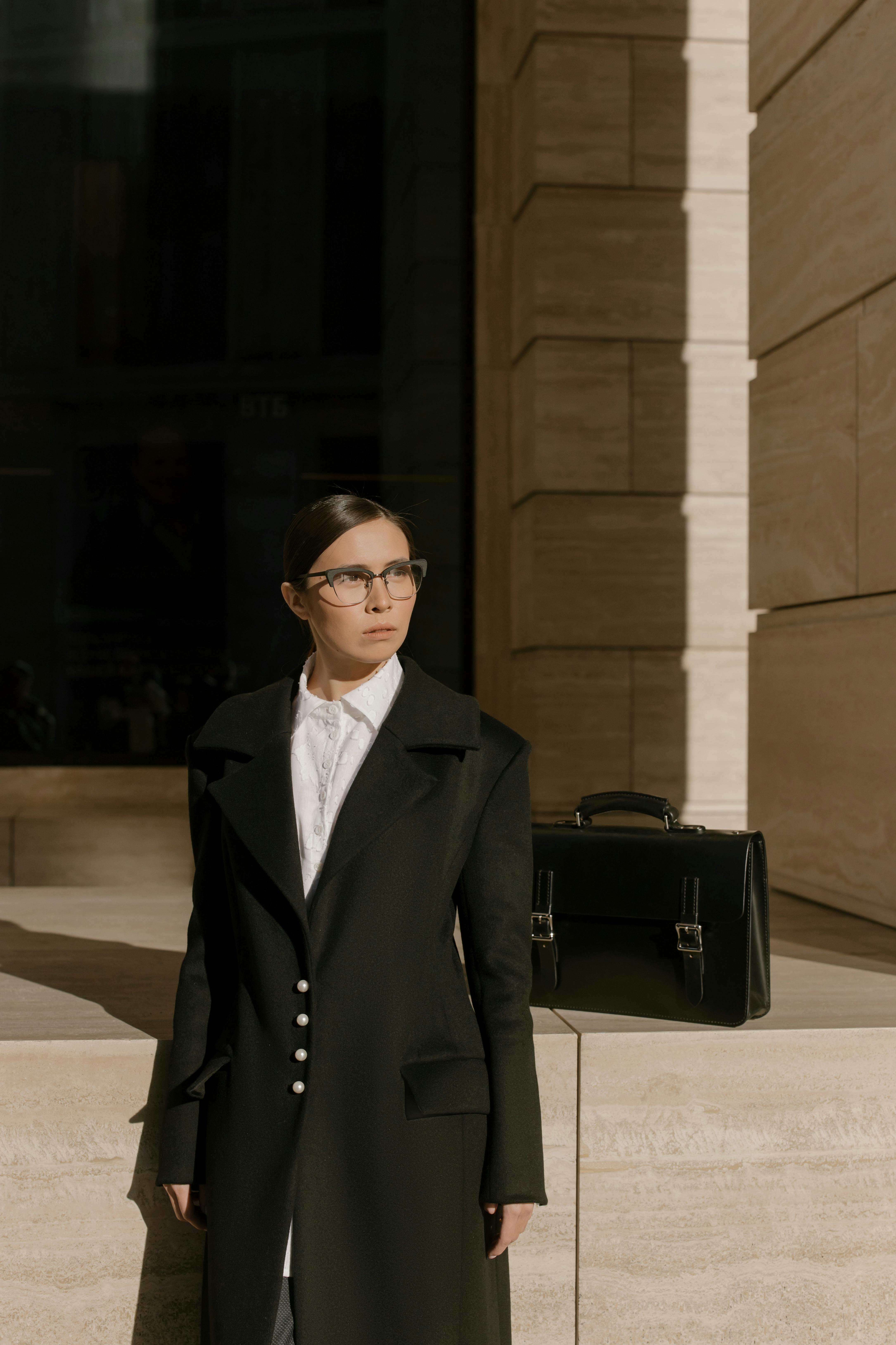 Confident professional woman with briefcase in city, exuding business style