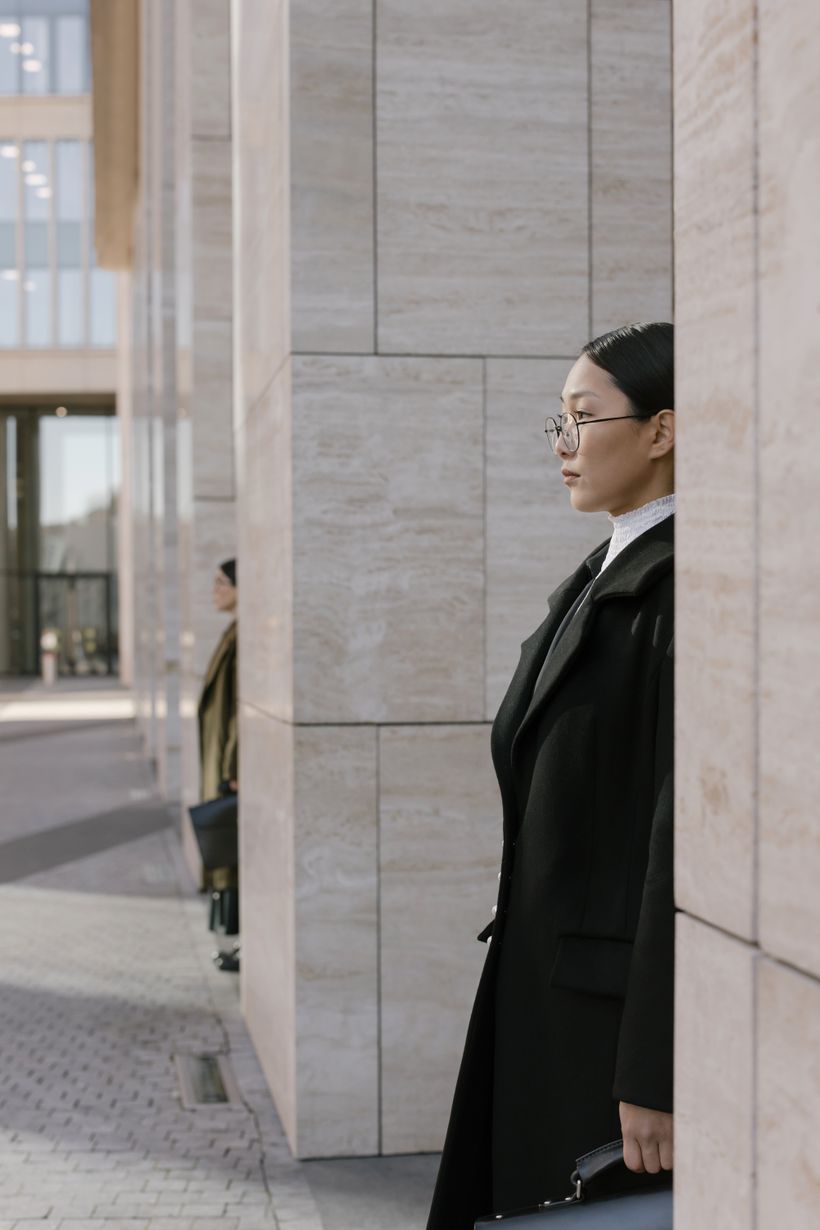 Model carrying a matte holdall in front of a concrete wall — photo by cottonbro studio on Pexels