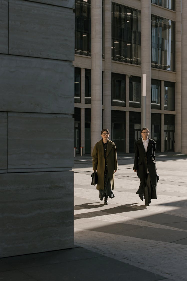 Women Wearing Coats Walking Together 