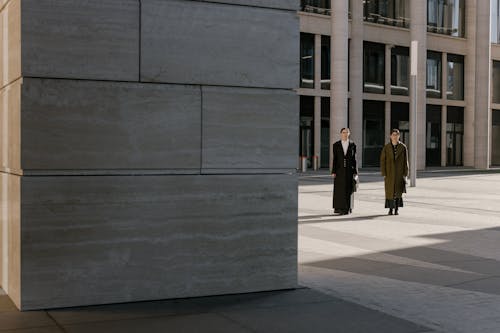 Women Standing Beside a Building