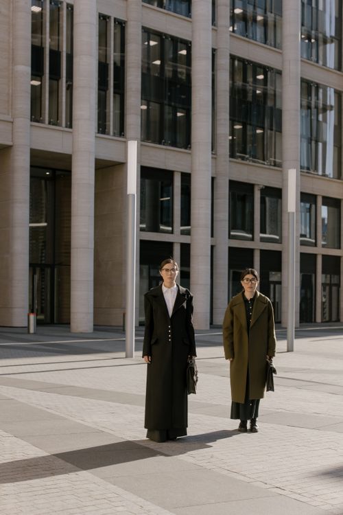 Free Two stylish businesswomen walking outdoors in an urban setting during daytime. Stock Photo