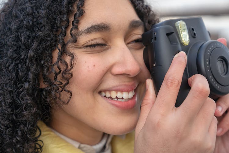 Hispanic Lady Taking Photo On Photo Camera In Street