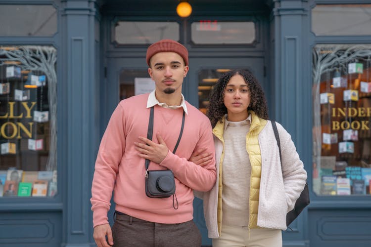 Trendy Young Hispanic Couple Standing On City Street During Vacation
