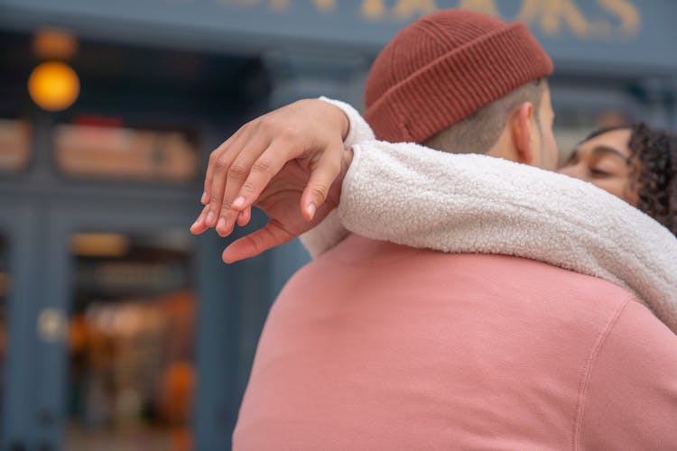 Romantic Young Hispanic Couple Hugging And Kissing On Street