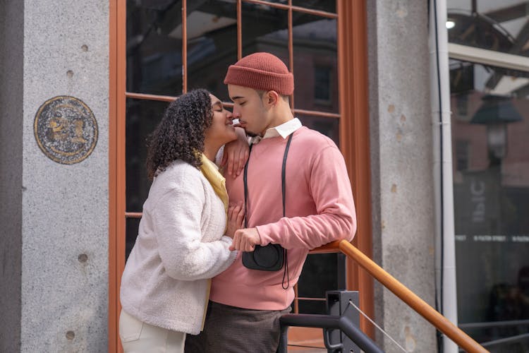 Cheerful Hispanic Couple Caressing On Street