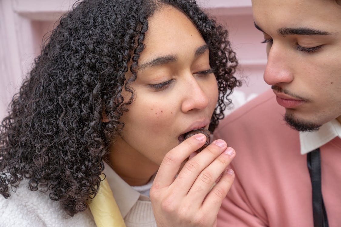 Free Hispanic couple with candy on street Stock Photo