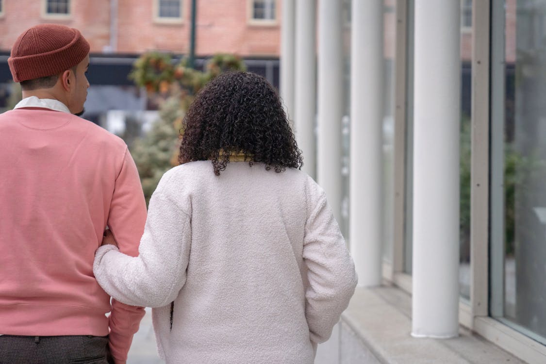 Young casual couple walking on street