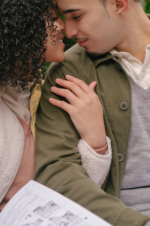 Tender crop Hispanic couple cuddling