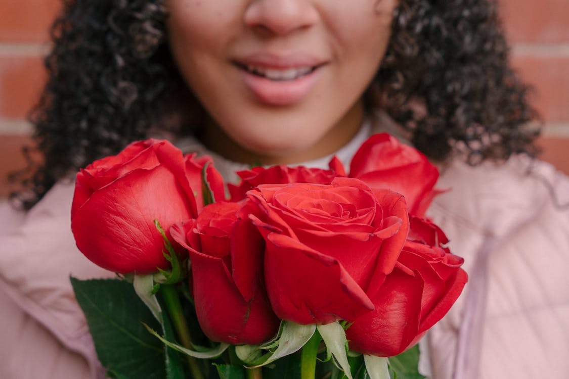 Crop Photo Of Woman Holding Red Roses · Free Stock Photo