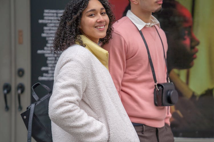 Delighted Hispanic Couple With Photo Camera And Backpack