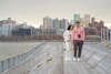 Free Full body of young ethnic couple with photo camera and red rose in blossom on pier of river Stock Photo