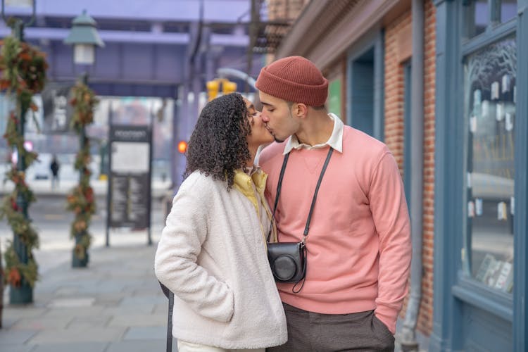 Romantic Young Hispanic Couple Kissing On Street