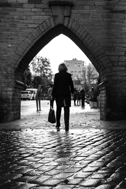 Black and White Photo of a Woman Walking