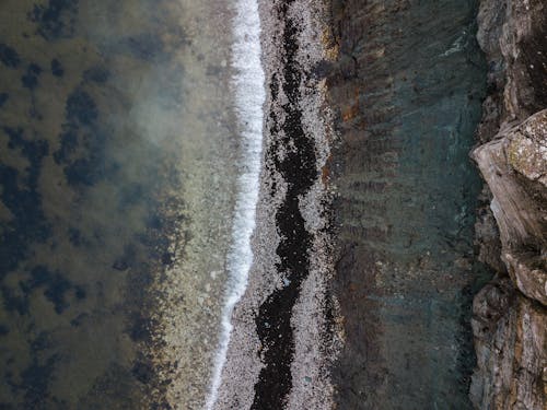 Aerial View of Waves Crashing on the Shore