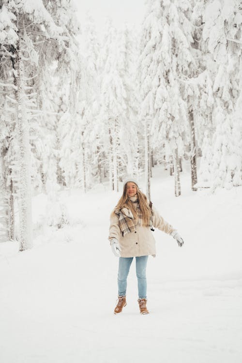 Free Woman Standing on Snow Covered Ground Stock Photo